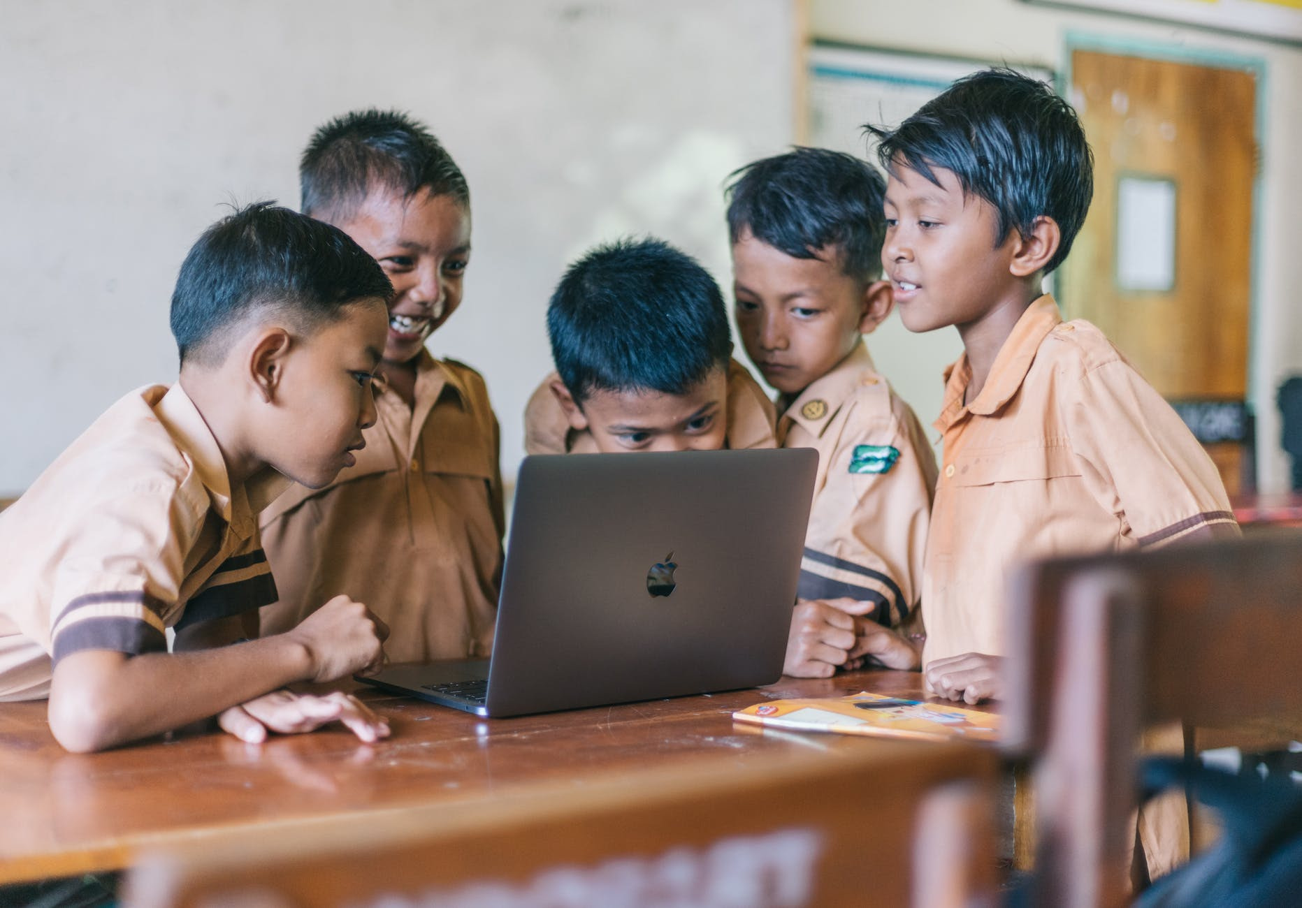 Edumgr boy using silver macbook indoors