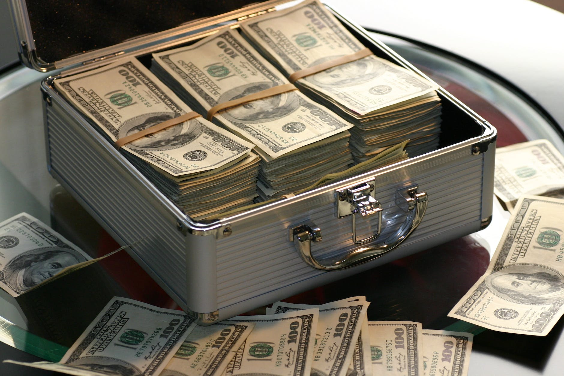 Making money hard cash on a briefcase