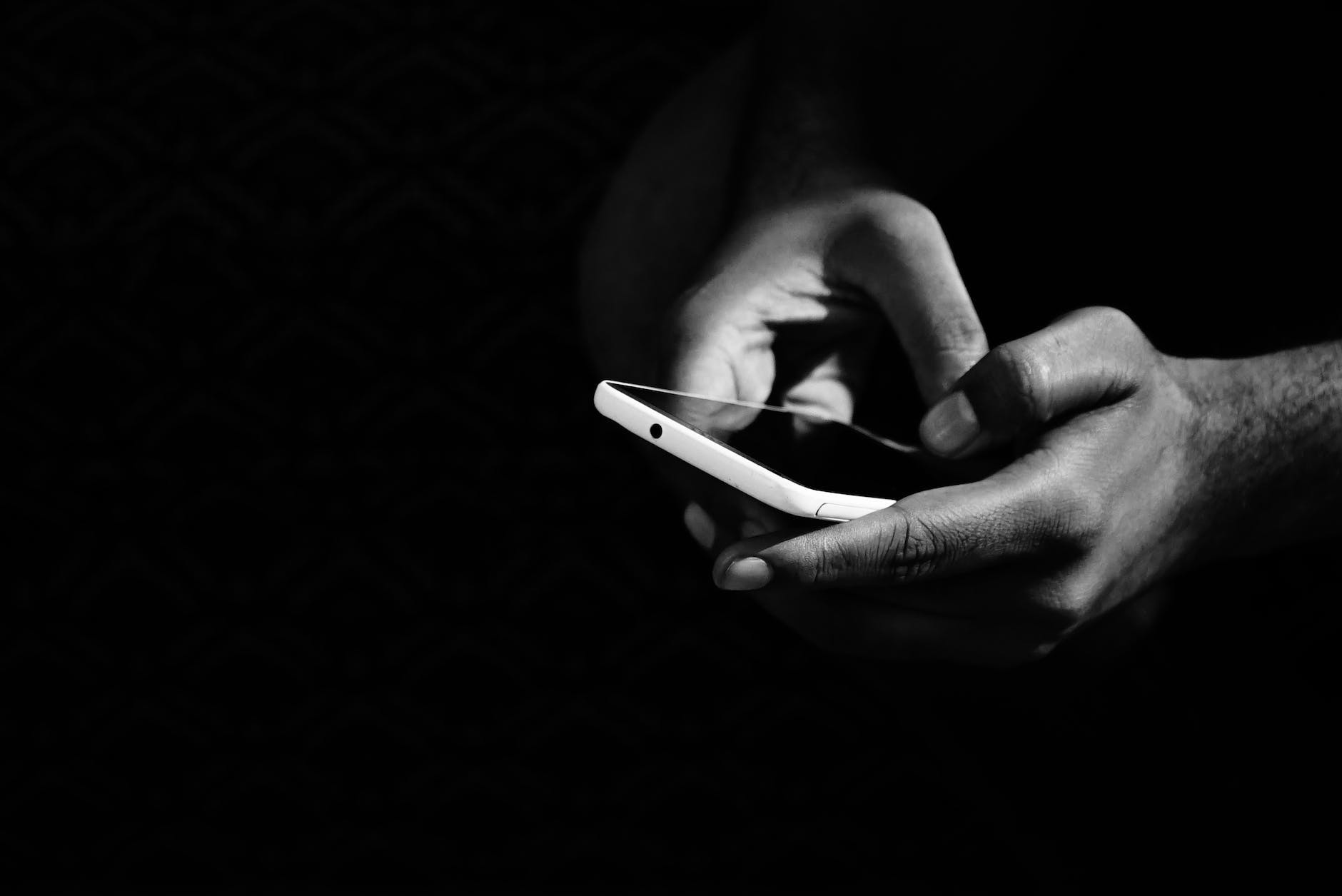 online business grey scale photo of person holding smartphone
